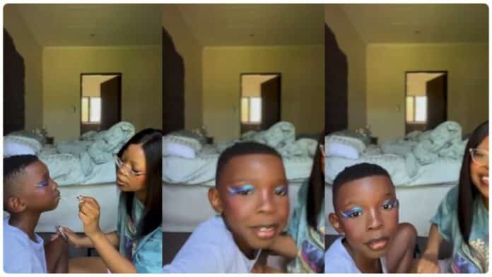 ‘She’s teaching him homosexuality” – Lady under fire for applying makeup on son’s face