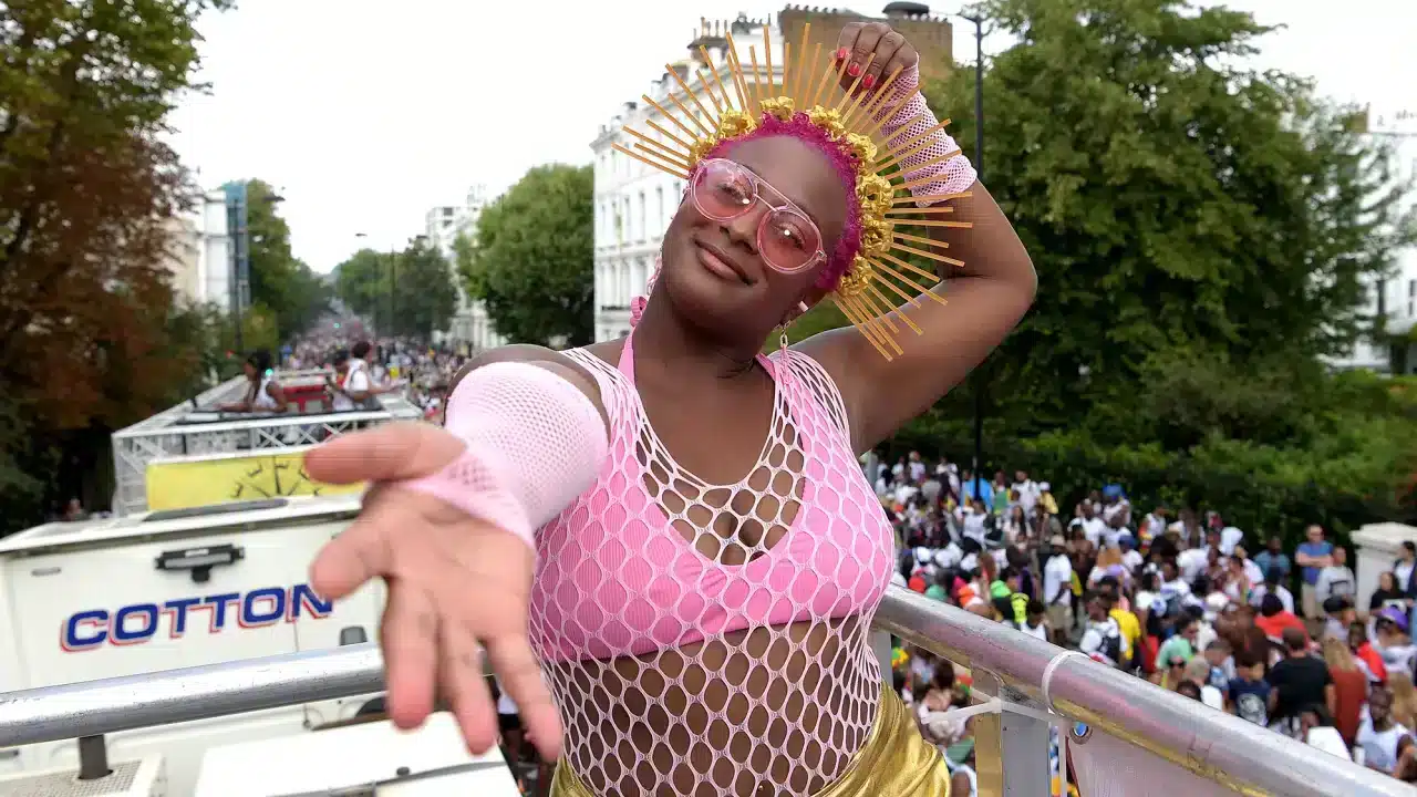 DJ Cuppy smiles while riding the Spotify x Socaholic float