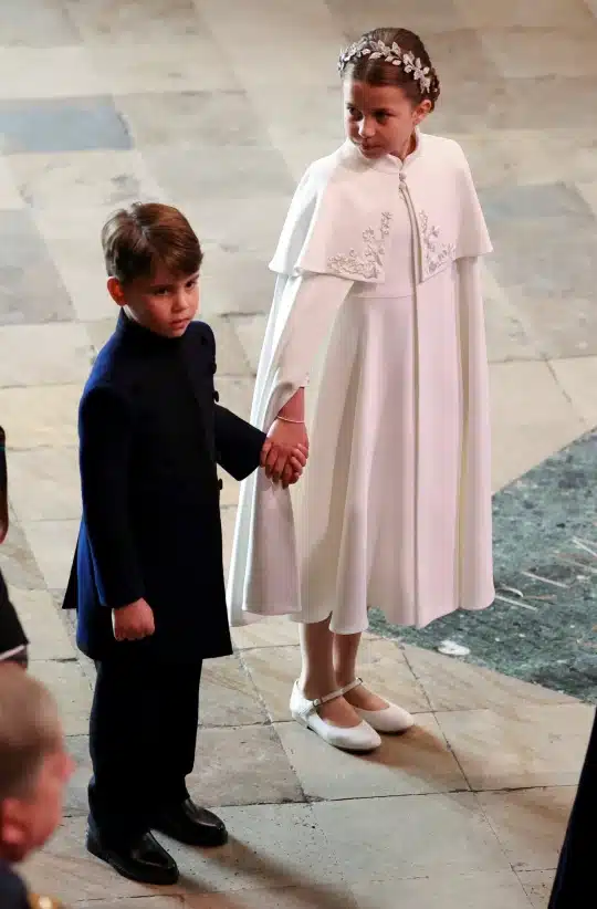 Adorable moment Charlotte holds Louis’ hand for their Grandpa Wales’ coronation