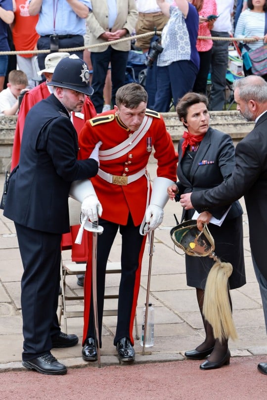 Soldier faints before the King and Queen show up for Garter Day procession