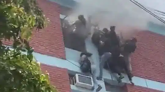 Students compelled to descend rope to escape a burning building