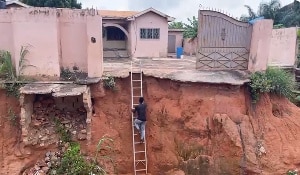 Bortianor residents ascend two wooden ladders to enter and exit home