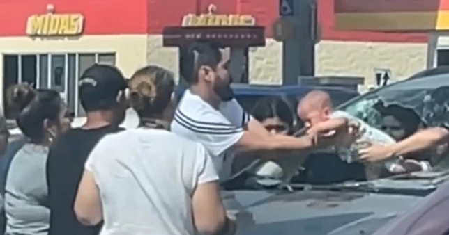 Anxious father breaks car window to save baby during heatwave
