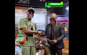 Ola Michael receives pair of sneakers from A Plus