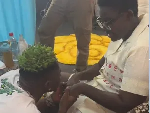 Supportive Shatta Wale holds hands with Afua Asantewaa as he offers prayers for her