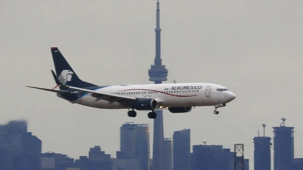 Passenger walks on wing after opening jet door in Mexico