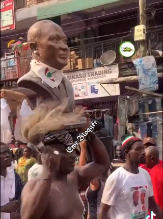 Video: Bare-chested Appiah Stadium carries Mahama’s bust during Kumasi walk