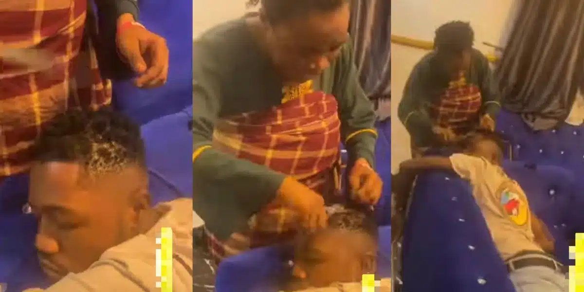 Controversial video surfaces online as Nigerian mother cut’s son’s dreadlocks while he sleeps