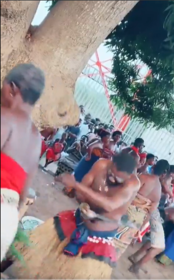 Fetish priest displays mastery of machete as he skillfully cuts his skin without injuries