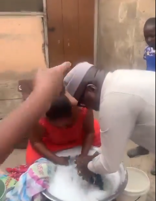 VIDEO: NPP’s Mike Oquaye Jr. washes woman’s clothes during campaign at Dome-Kwabenya
