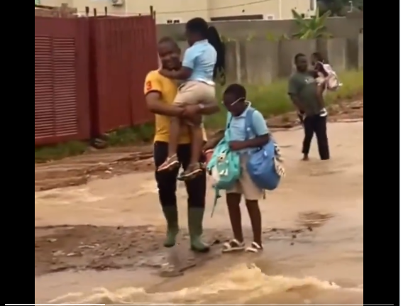 Video: Adenta MP carries school children to cross flooded road after Wednesday’s rainfall