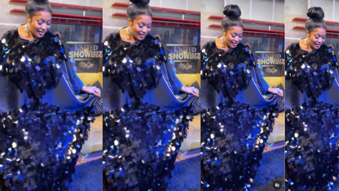 MzGee looks classy in a black glittering maxi dress and flawless makeup