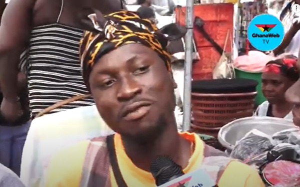 How okra seller in dome market attracts buyers with his scarf